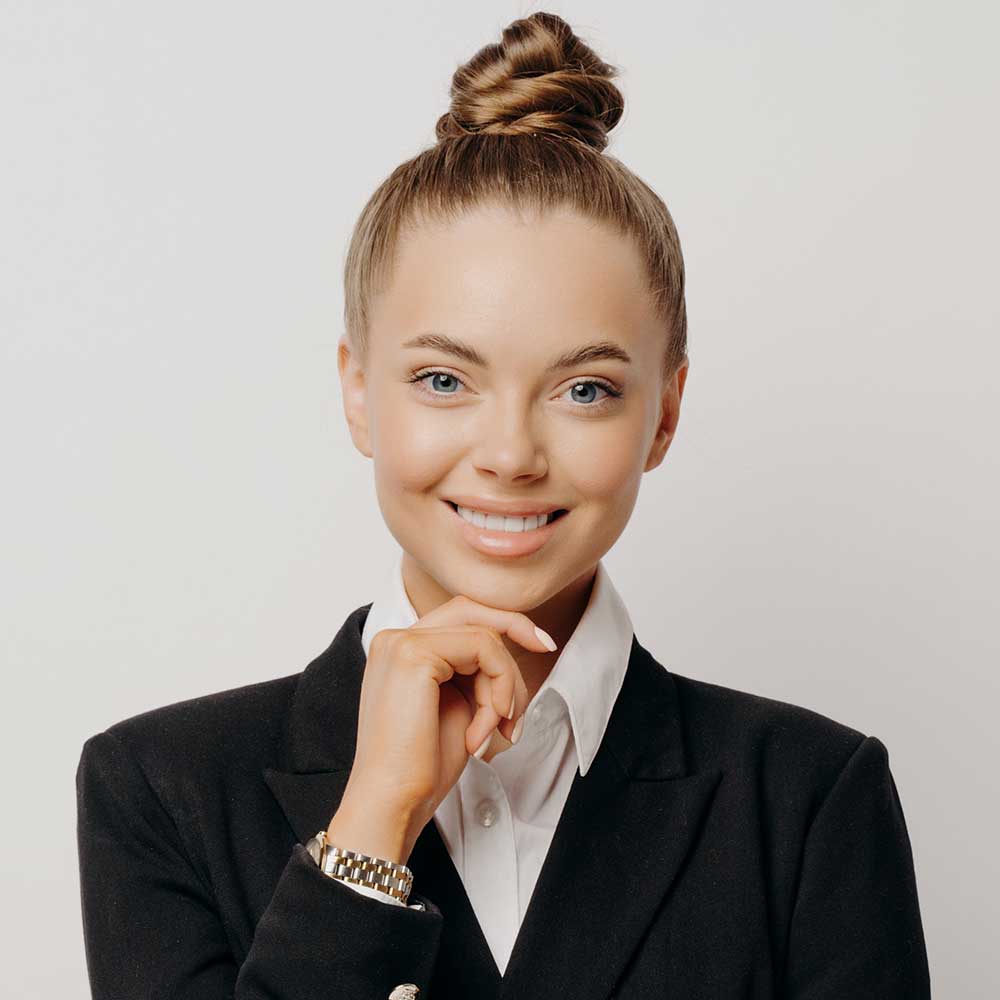 happy-female-office-worker-with-hand-on-chin-RRP5GH2.jpg